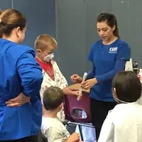 Dental Assisting students demonstrating oral health with kids.