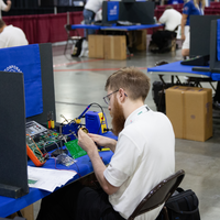 Student working on wires and circuit board
