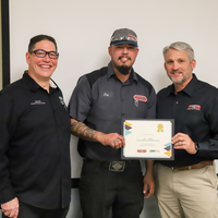 Student and faculty at training graduation ceremony