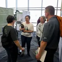 Judges listening to poster presentation