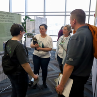 Judges listening to poster presentation