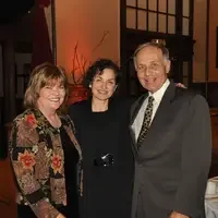 Mary (M.C.) Niland at Founders Dinner standing with Guy Hurlbutt and another guest
