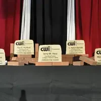 Cornerstone awards for founding CWI trustees on a table with bricks