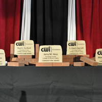 Cornerstone awards for founding CWI trustees on a table with bricks