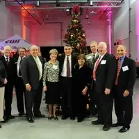 Mary (M.C.) Niland standing with a group of people at an event