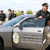 Reid exiting a CWI Law Enforcement vehicle