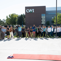 Group of people in front of a large campus building