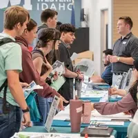 Students chatting with staff at resource fair