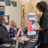 Student chatting with booths at resource fair