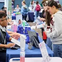 Students talking to employer at Job Fair