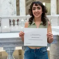 Student award recipient holding certificate