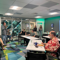 Host speaking to students during workshop