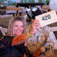 Supporter holding up paddle to make a bid
