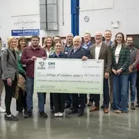 Group of people holding check in lab