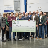 Group of people holding check in lab