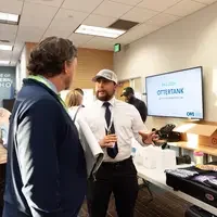 Man chatting with participant showcasing business idea 