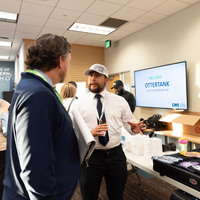 Man chatting with participant showcasing business idea 