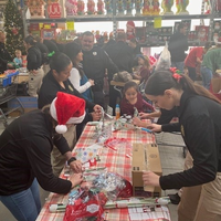 People surronding table, wrapping presents