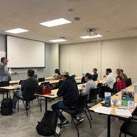 Students in a classroom watching a speaker