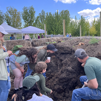 Students checking out soil on farm