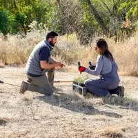 Student planting at Restoration Week - Choosing plants