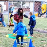 CWI students working with children on obstacle course