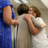 Student hugs faculty