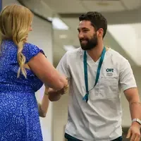 Graduate shakes hand of faculty
