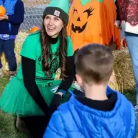 CWI students working with children presenting pumpkins
