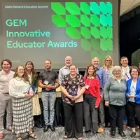 Group photo posing in front of a screen that says GEM Innovative Educator Awards