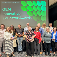 Group photo posing in front of a screen that says GEM Innovative Educator Awards