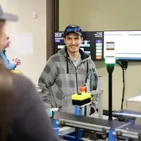 Student explaining equipment to Micron guests