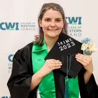 Student holding decorated cap