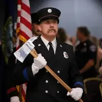 CWI fire instructor marching into ceremony