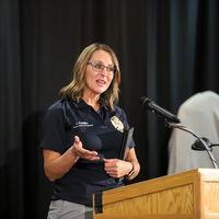 Courtney Santillan speaking at ceremony