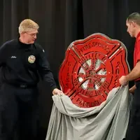 Student giving class gift of a sign to instructor