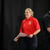 Student walking across stage celebrating 