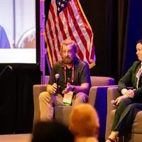 Ander Sundell speaking into mic sitting in chair