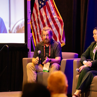 Ander Sundell speaking into mic sitting in chair