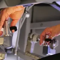 Surgeons perform procedures using an interactive robot with instrument arms and 3D HD cameras.