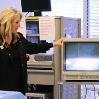 Mona Bourbonnais, CWI’s Surgical Technology program chair, demonstrates the da Vinci.
