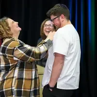 Student and family member laughing at pinning ceremony