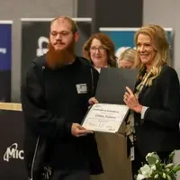 Casey Subera with April Arnzen holding a certificate