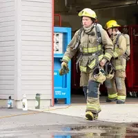 Students putting their turnouts and air packs on