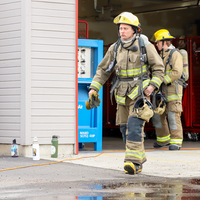 Students putting their turnouts and air packs on