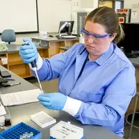 Student working on Biology lab with equipment 