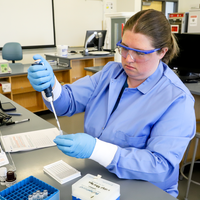 Student working on Biology lab with equipment 
