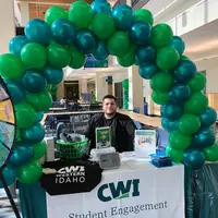 Tutor at welcome table with balloons
