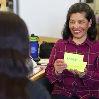 Teresa Tafia de Yensen holding up medical terminology flashcards