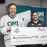 President Jones accepting Steelheads check for CWI scholarships